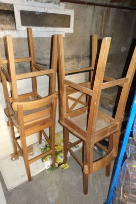trois chaises en bois assises l'une à côté de l'autre dans une pièce