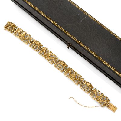 une photo représentant un bracelet en or et diamants ainsi qu'un écrin noir