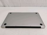 the back of a silver laptop computer sitting on a white surface