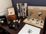 many watches on display on a table in a room