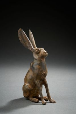 a bronze statue of a rabbit sitting on its hind legs