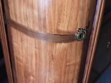a close up of a wooden cabinet with a metal handle