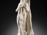 a white marble statue of a woman holding a child