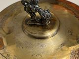 a gold plate with a statue on top of it