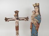 statue of jesus on the cross with a woman holding a child