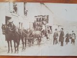 an old photo of a horse drawn carriage with people on it