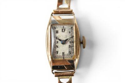 an image of a close up of a wrist watch on a white surface