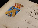 an old document with a coat of arms and a crown on it