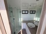 a bathroom with a sink, shower, and mirror in it
