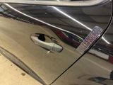 a close up of a car door handle with a sticker on it