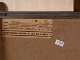 a brown piece of luggage sitting on top of a wooden table