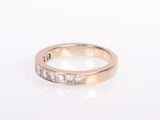 a close up of a diamond ring on a white surface