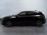 the black car is parked on the concrete floor in the room
