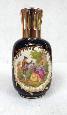 a black vase with a picture of a couple of people on it