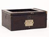 a small wooden box with a label on it