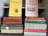 several old books are stacked on a shelf in a library
