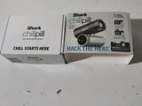 packaging of a black and white camera sitting on top of a white table