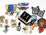 a lot of military badges and medals on a white surface