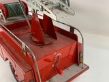 a red fire truck with a ladder on the back of it