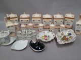 many different types of porcelain dishes and cups on the table