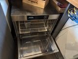 an image of a stainless steel dishwasher with a basket in it