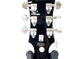 the headstock of an electric guitar with a black body and a white background
