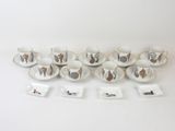 un grand nombre de tasses et de soucoupes sur une table