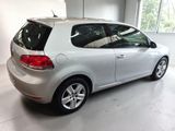 the back of a silver volkswagen golf parked in a garage