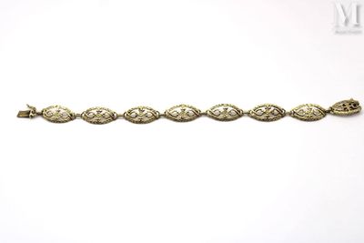 a close up of a gold bracelet on a white background