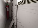 a red fire extinguisher in a narrow room