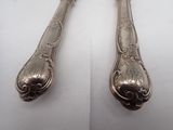 pair of silverware spoons on a white surface with a white background