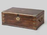 an old wooden box with a lock on top of it
