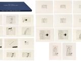 an image of a collection of drawings and a book on a white surface