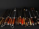 a lot of different types of knives on a black background