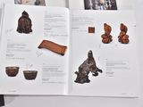 a book with a picture of a buddha and other items