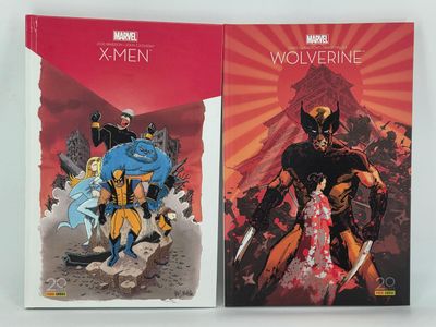two books of wolverine and wolverine comics on a white surface