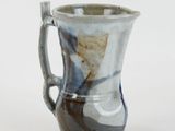 a close up of a coffee cup on a white surface