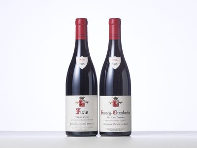 two bottles of red wine sitting on top of a table