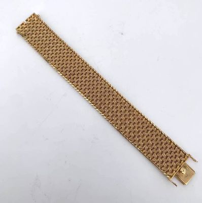 a gold bracelet with a clasp on it