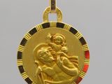 a close up of a gold medal with an image of a woman holding a child