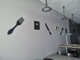 a clock on the wall of a restaurant with a fork and knife on it