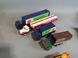 a lot of toy cars and trucks that are on the table