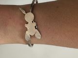 a close up of a person ' s arm with a silver bracelet on it
