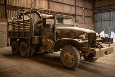 a old military truck parked in a garage