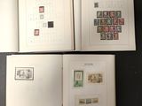 two pages of a book with stamps on them sitting on a table
