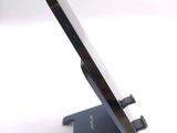 a cell phone sitting on a stand on a white surface
