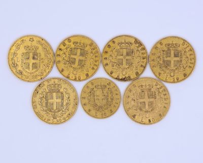 a group of five gold coins with the symbols of different countries