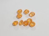 an image of a group of orange beads sitting on top of a white surface