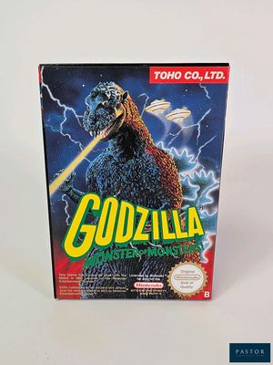 La boîte du jeu « Godzilla, le maître des monstres » est posée sur une surface blanche