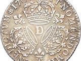 a close up of a coin with a crown on it